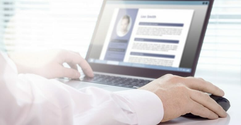 Job seeker and applicant writing his resume and CV with laptop. Modern and visual electronic curriculum vitae in social media. Work experience document in computer screen. Job search and unemployment.